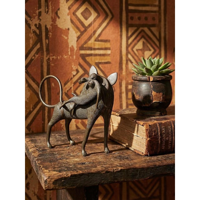 A very beautiful handcrafted bronze statuette from Cotonou, Benin, Benin, Dahomey, Africa. It depicts a lion, hyena, or...