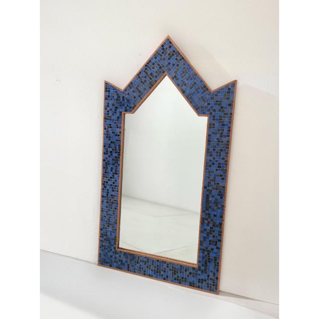 Decorative wall mirror featuring a mosaic tile covering in shades of blue and black. The mosaic is applied to a wooden...