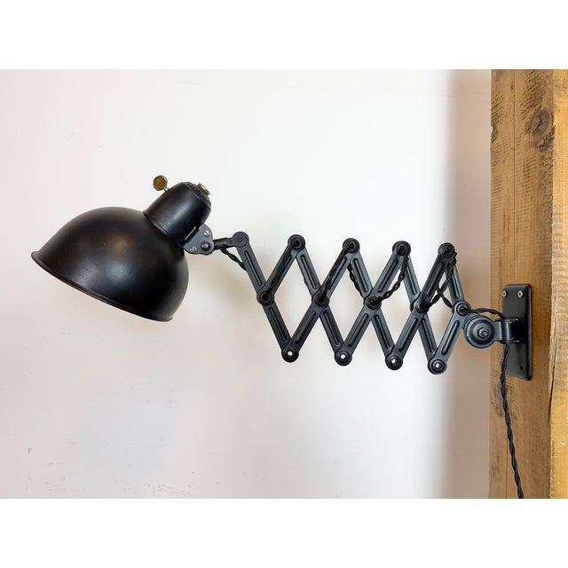 Industrial adjustable Bauhaus scissor wall light designed by Christian Dell and produced by Kaiser Idell in Germany during...