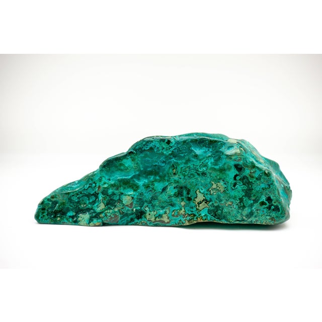 Richly marbled chrysocolla-malachite specimen with a vibrant emerald color. The beautiful blue-green of chrysocolla has...