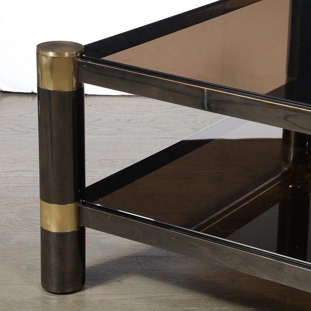 This Mid-Century Modernist two-tier cocktail table by Karl Springer, crafted in America circa 1980, exemplifies the...