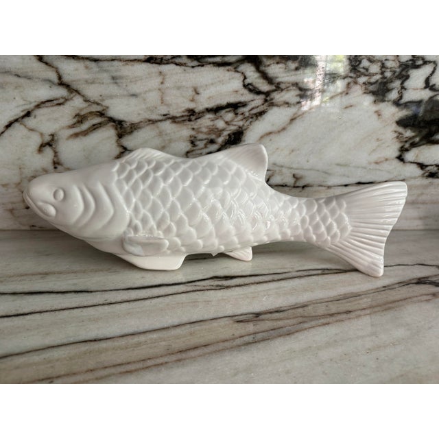 Pair of Palm Beach vintage market find true to size, white finish ceramic Koi fish figurines. No maker's mark.