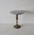 Well crafted Hollywood Regency brass drinks table featuring a round marble top. The pedestal base is decorated with a...