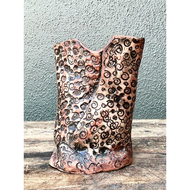 This striking studio pottery vase is a masterclass in organic form and textural exploration, drawing inspiration from...