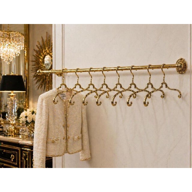 An exceptional and rare set of eight luxurious wardrobe hangers crafted in solid brass, dating to the 1970s and executed...