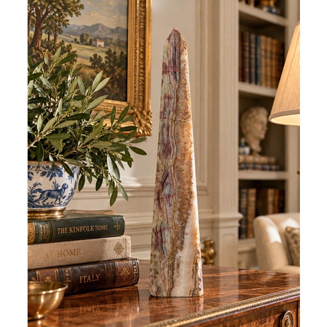 A beautifully proportioned marble obelisk in richly veined shades of green and brown. The sculptural silhouette and...
