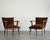 A striking pair of vintage Danish Modern lounge chairs crafted in solid teak, showcasing sculptural arms and elegantly...