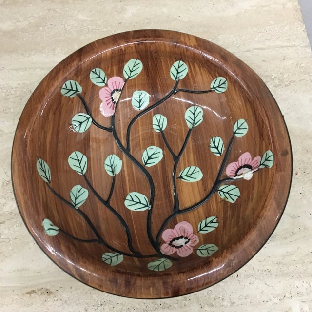 Vntage Italian footed bowl crafted from ceramic with a hand-painted floral design featuring pink blossoms and green leaves...