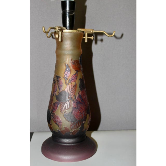 Glass paste lamp signed Gallé TIP, decoration of flowers and leaves, red and orange color, two lights, foot and cap, very...