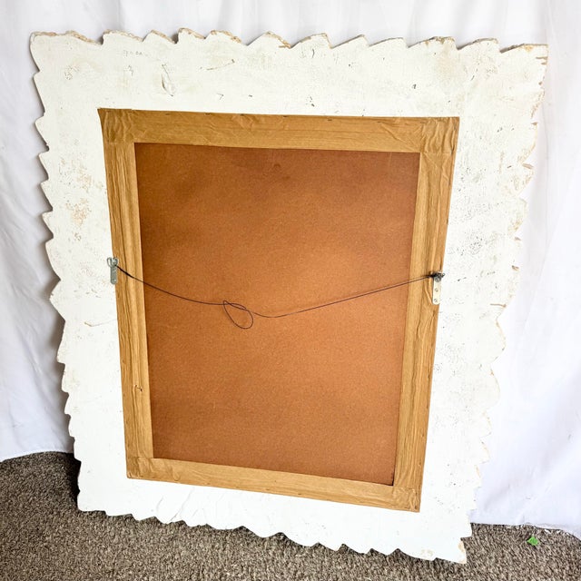 This vintage Boho Chic wall mirror features a sculptural faux bamboo and banana leaf motif, richly textured to evoke the...