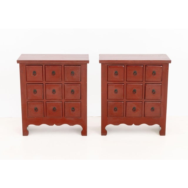 Pair of Chinese Style Red Painted Wood Apothecary Chests, each with nine drawers. 30.5" H x 26.75" W x 12.25" D....
