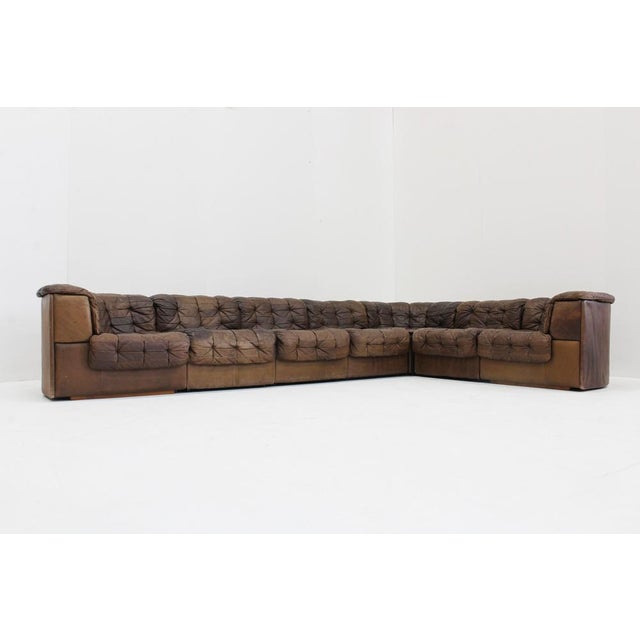 Vintage De Sede DS 11 modular sofa in brown patchwork leather from Switzerland, 1970s. Large lounge sofa which has...