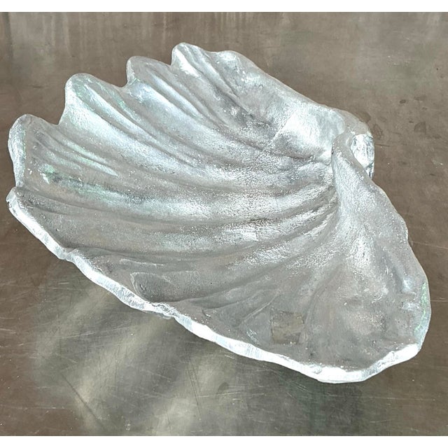Inspired by the elegance of the ocean, this vintage cast pewter clam shell bowl is a striking decorative accent that...