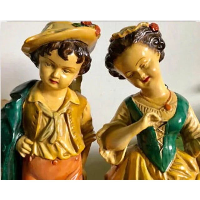 Beautiful Borghese Swiss boy & girl statues. Color is amazing on both and both are marked on the bottoms.