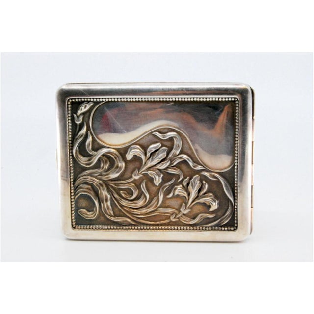 Silver Cigarette Case with Embossed Floral Motifs, in Very Good conditions. Designed 1980 to 1989 This piece has an...