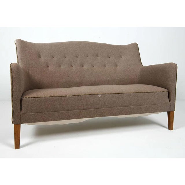 A Danish mid century sofa with great lines and a very good look. It looks like it could be a Carl Malmsten design, however...