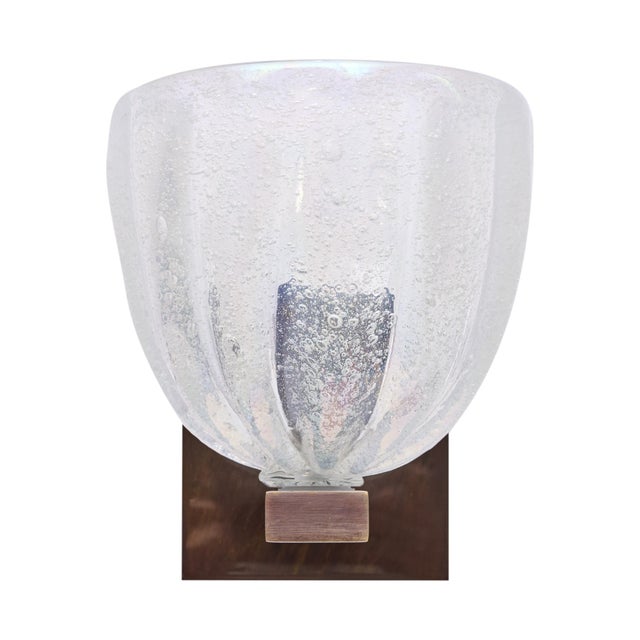 A striking pair of Italian Murano glass wall sconces, each featuring a substantial hand-blown glass shade worked in the...