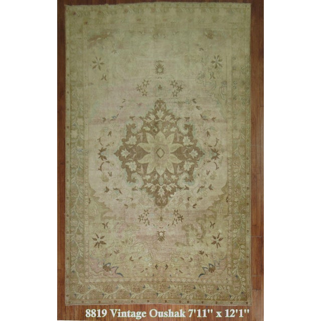 A room size vintage Turkish rug with a central medallion on a light pink field. Measures: 7'11'' x 12'1''.