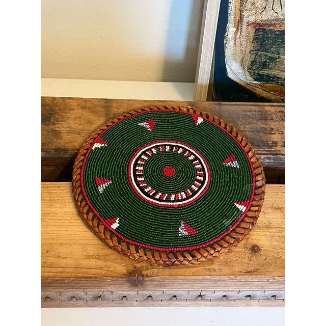 Possibly meant to be a placement, coaster or table decor. Vintage handwoven and beaded. This Piece has nice patina and...