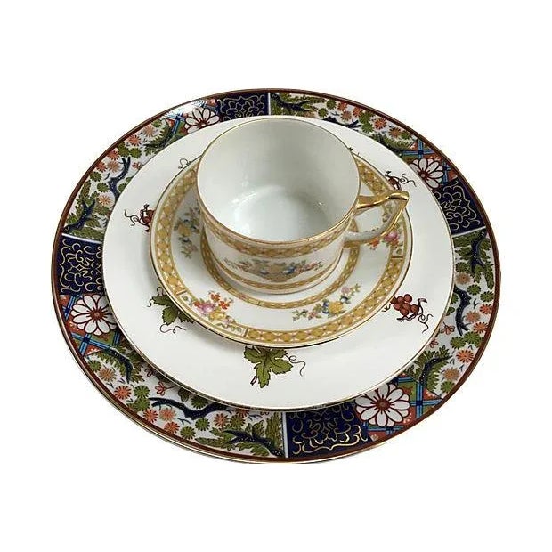 Offering a unique place setting of fine porcelain consisting of a four-piece porcelain setting with Imari-style dinner...