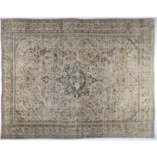 This beautiful antique Persian rug features a softly faded, time worn patina that gives it an elegant and earthy...