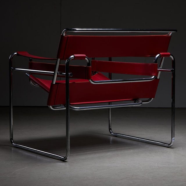 Tubular steel chair by Marcell Breuer with vibrant red leather. The Wassily chair was designed in the 1920s for Knoll;...