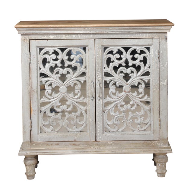 An unusual painted cabinet, console or sideboard with carved door fronts and stepped molding at top and bottom. The...