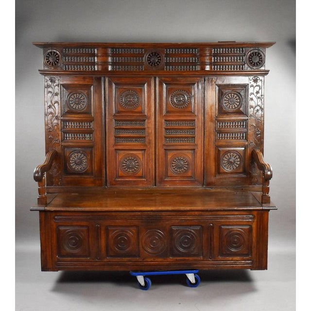 Carved Oak Panelled Settle / Hall Bench Item Code: LC1440 A substantial and highly decorative antique oak settle,...