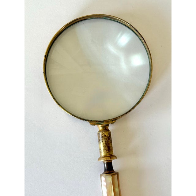 Beautiful and functional brass magnifying glass with a Palm Beach style mother of pearl inlay handle, suitable for viewing...