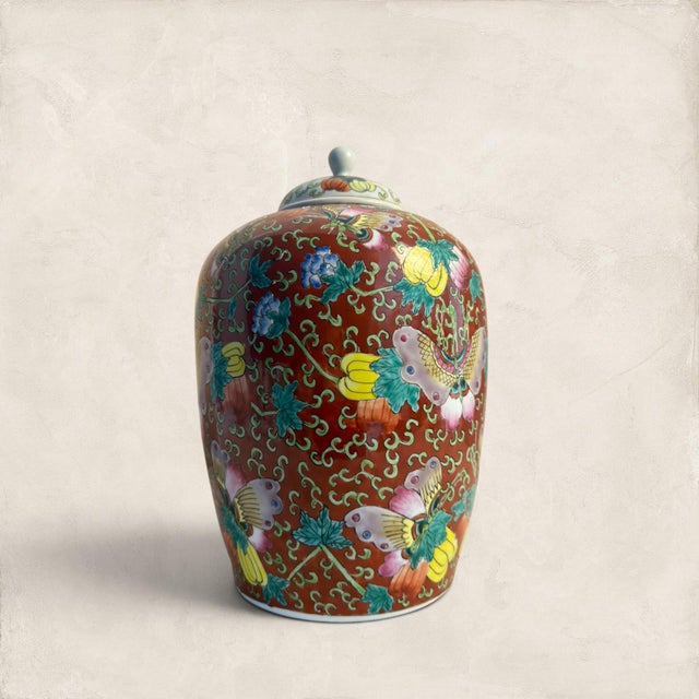 That bold red ground stops you in your tracks. This large ceramic ginger jar carries the full weight of the famille rose...