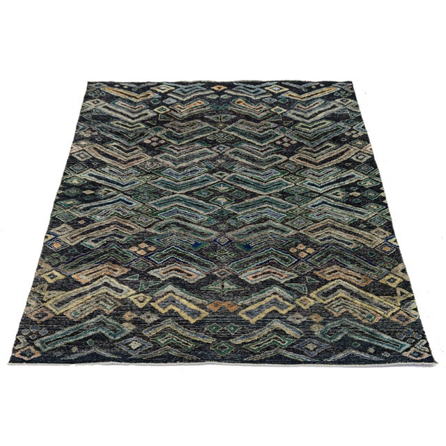 Elevate your space with this modern Tulu rug, showcasing a striking all-over pattern of chevrons and diamonds inspired by...