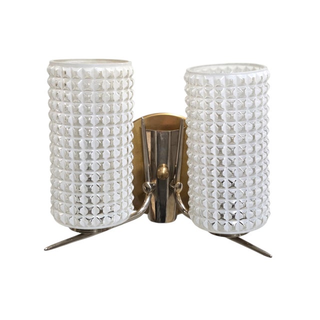A striking set of three mid-century modern double-light vintage wall sconces, each featuring two tall diamond-cut textured...