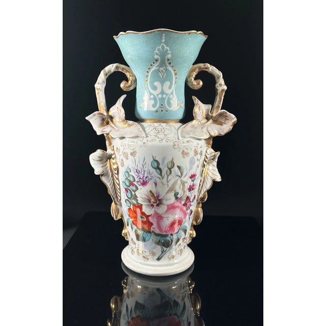 An Old Paris Porcelain handled vase. Floral pattern with two-tone blue and white ground. 19th Century. As is typical with...