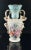 An Old Paris Porcelain handled vase. Floral pattern with two-tone blue and white ground. 19th Century. As is typical with...