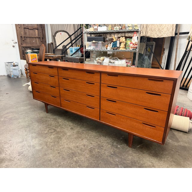 A rare 1960s Danish Modern teak 12-drawer lowboy credenza dresser and a masterpiece of mid-century Scandinavian design....
