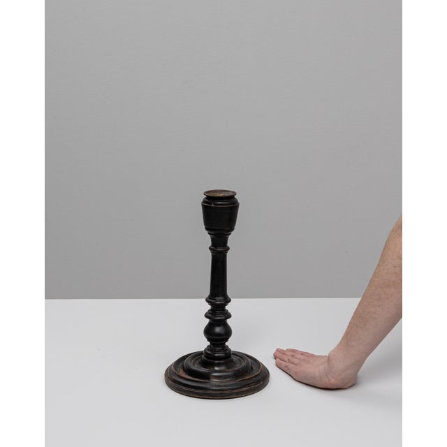 This 19th-century French candlestick holder embodies understated elegance with its classic turned silhouette and deep...
