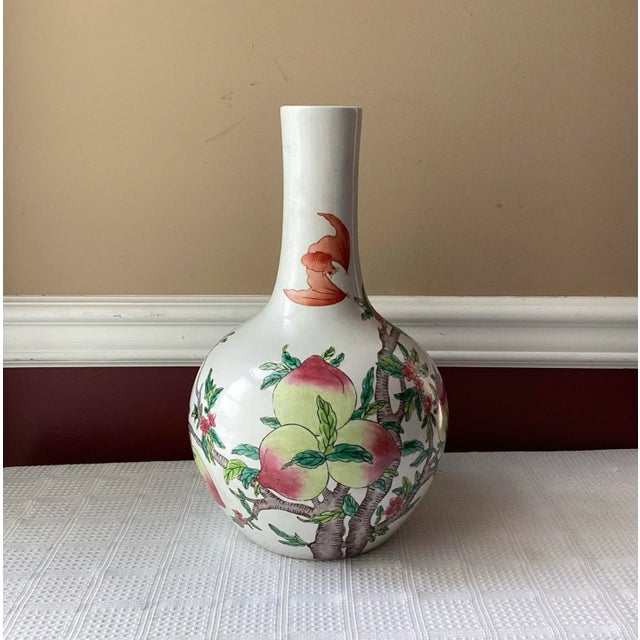 Celebrate the artistry and auspicious symbolism of traditional Chinese porcelain with this elegant Famille-Rose vase,...