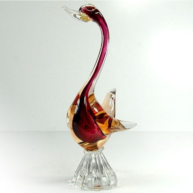 A beautiful decorative Sommerso figurine made of warm-toned glass with light gold accents. It was crafted in Murano. The...