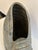 Striking large ceramic sculpture in the shape of a nautilus shell in a neutral shade of grey.
