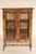 Aesthetic movement bamboo and lacquer bookcase, circa 1910. with a black lacquer top with red floral decoration, two glass...