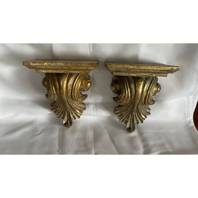 Vintage ornate gold faux giltwood wall sconce shelf. Featuring a stunning French Renaissance-inspired design with detailed...