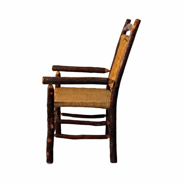 Vintage Maine artisan-made hickory bench with woven caned seat and back rests. Seat dimensions:W:42 x D:20 inches. Two...