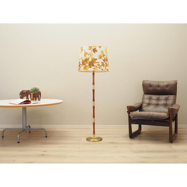 The lamp was made in the 1970s, Danish production. Made of teak wood and metal. Lampshade covered with multicoloured...