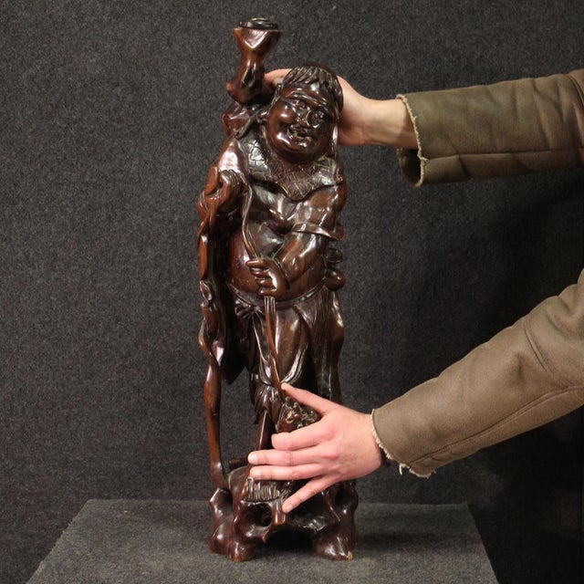 Sculpture from the mid-20th century. Finely carved and crafted exotic wooden object depicting a fisherman with fish, of...