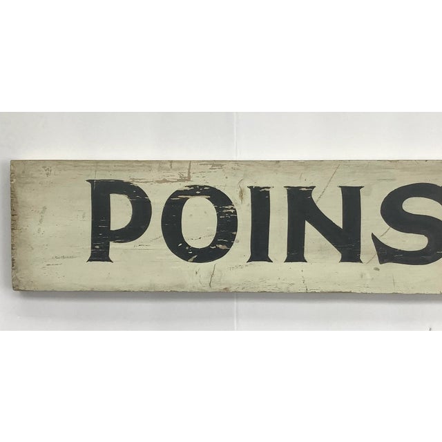 Vintage black and white wood Poinsettias farm stand sign. Sign has wear, discolorations, paint loss, scratches.