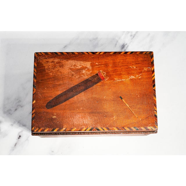 Dating to circa 1910, this wonderfully evocative antique cigar box is a charming example of early 20th-century folk art...