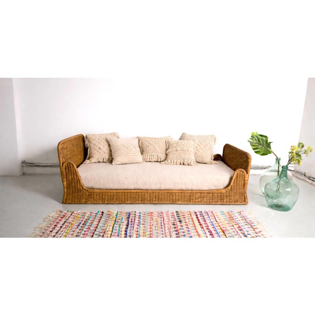 Timeless design for this vintage daybed, made in France in the 1960s. Elegant and unique vintage rattan daybed with two...