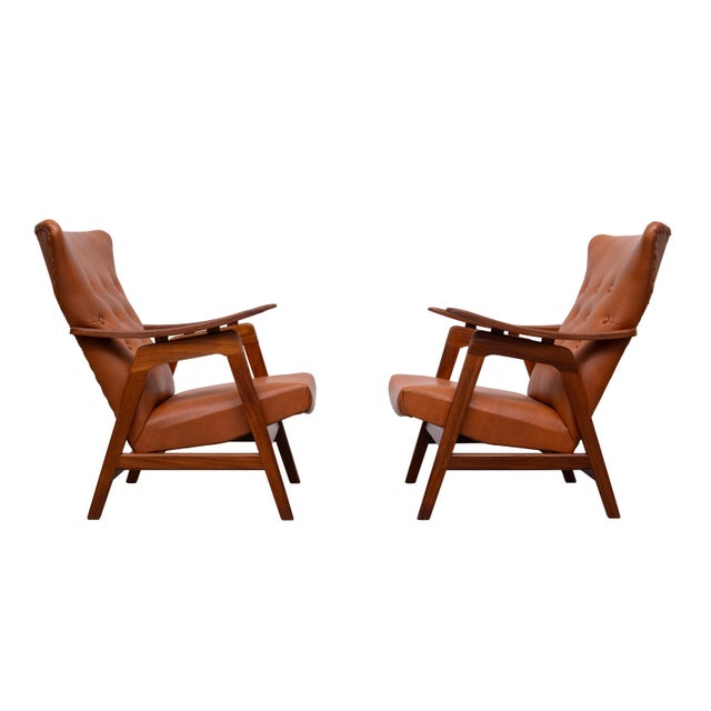 lovely set off lounge chairs , Teak frame ,floating armrests , comes with a cognac color faux Leather upholstery . tufted...