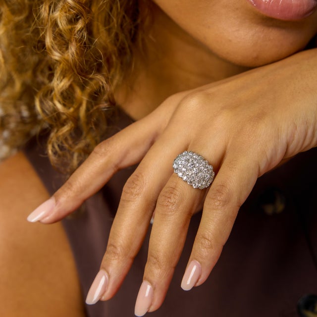This Edwardian diamond cluster ring is a refined expression of early 20th-century elegance, defined by harmony, softness,...