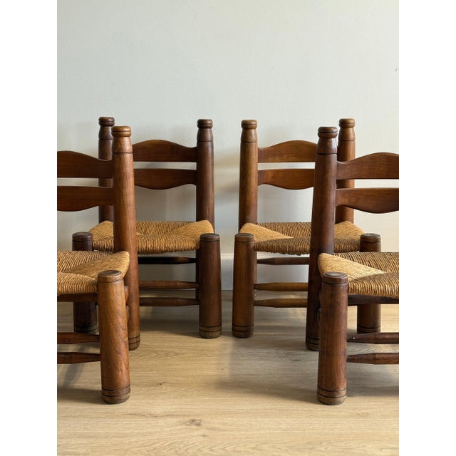 A charming set of four low rush-seat chairs by French designer Charles Dudouyt (unmarked), known for his rustic modernist...
